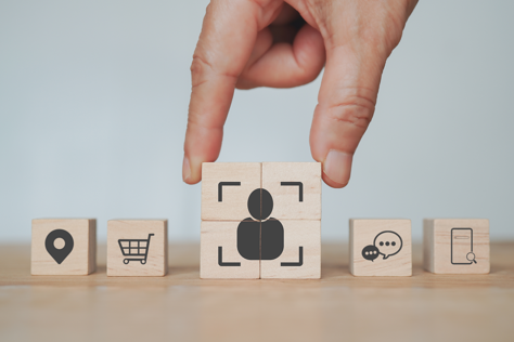 Wooden blocks with icons representing targeting of users